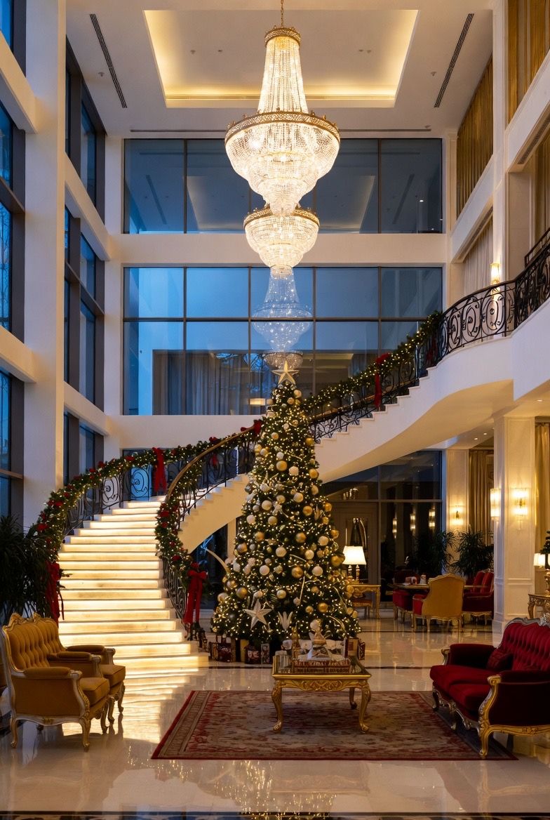 Concept: a grand foyer with a sweeping staircase and tall tree