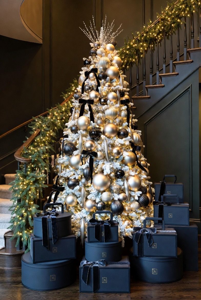 Concept: a gold and ivory tree at a staircase with navy gift boxes